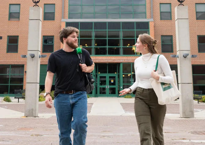 Two students walking out of MLLC