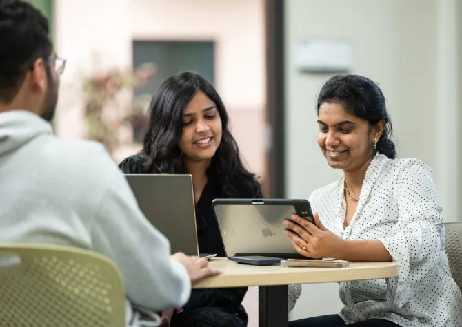 computer science students looking at computer together