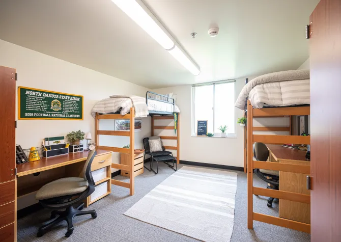 A newly renovated room in Pavek Hall with two lofted beds.