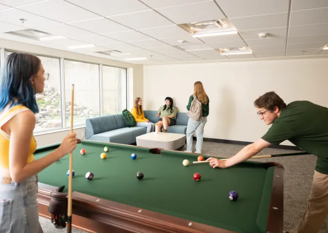 students playing pool in Pavek Hall 