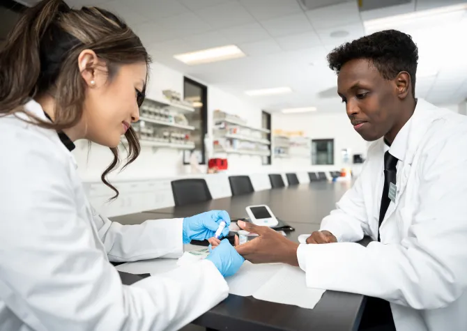 Pharmacy students performing lab test
