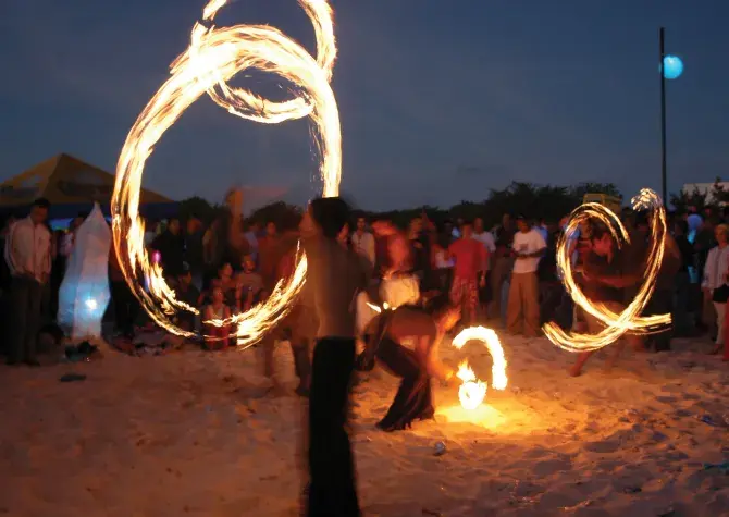 Large group of people gathered to watch a fire thrower