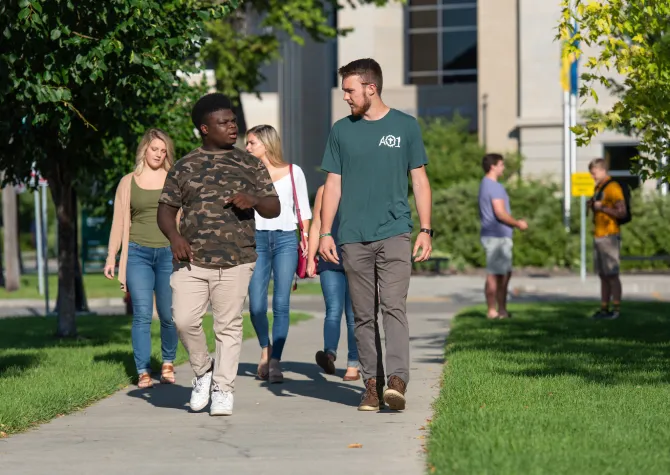 Students walking on campus on a sunny day