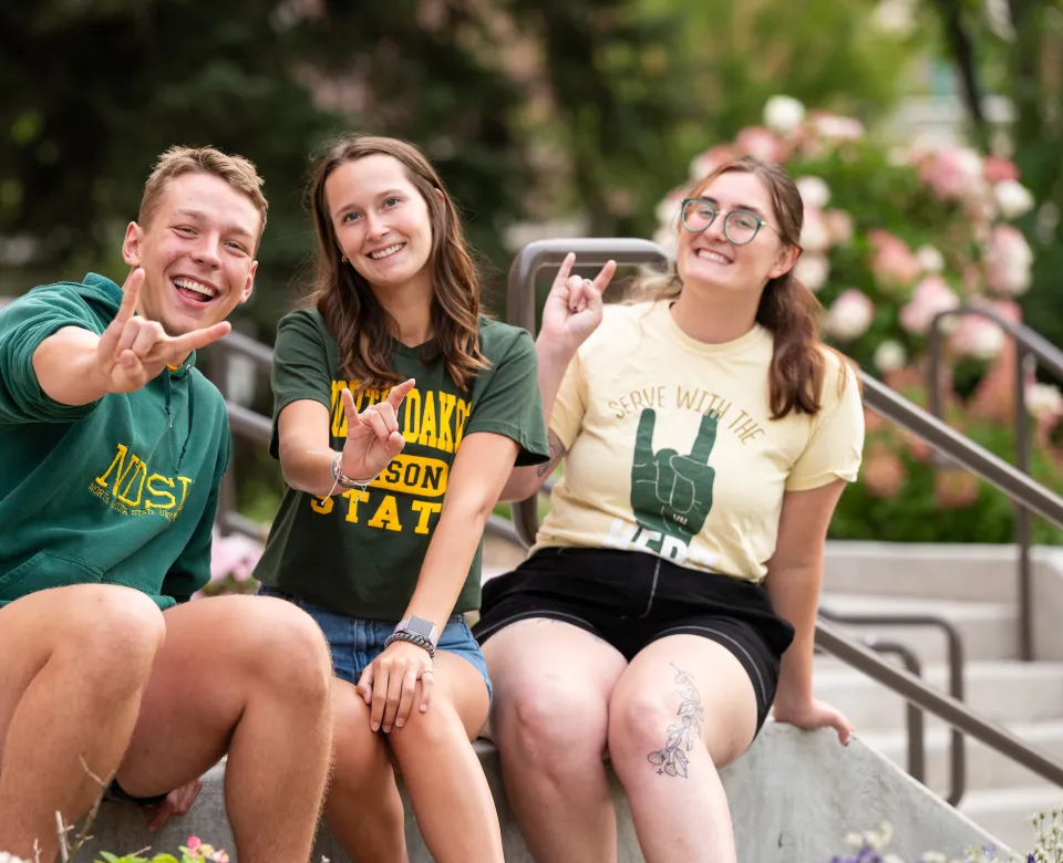 three students on steps