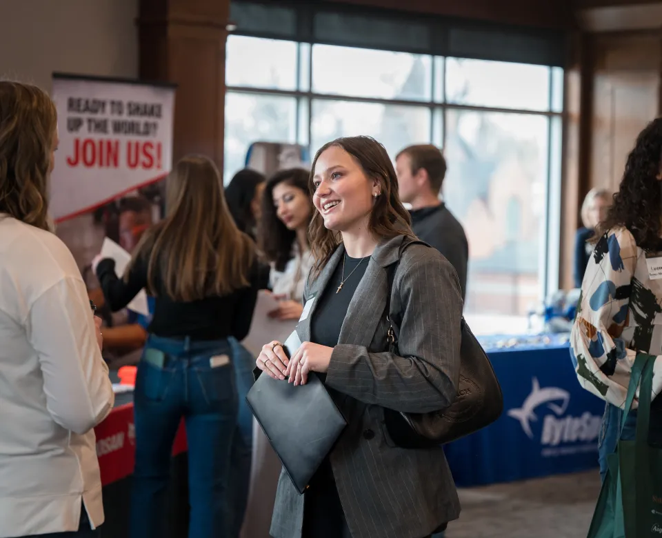women talking at an expo