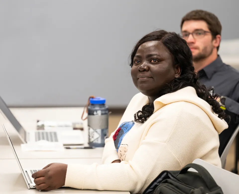 graduate students listening to faculty in a classroom