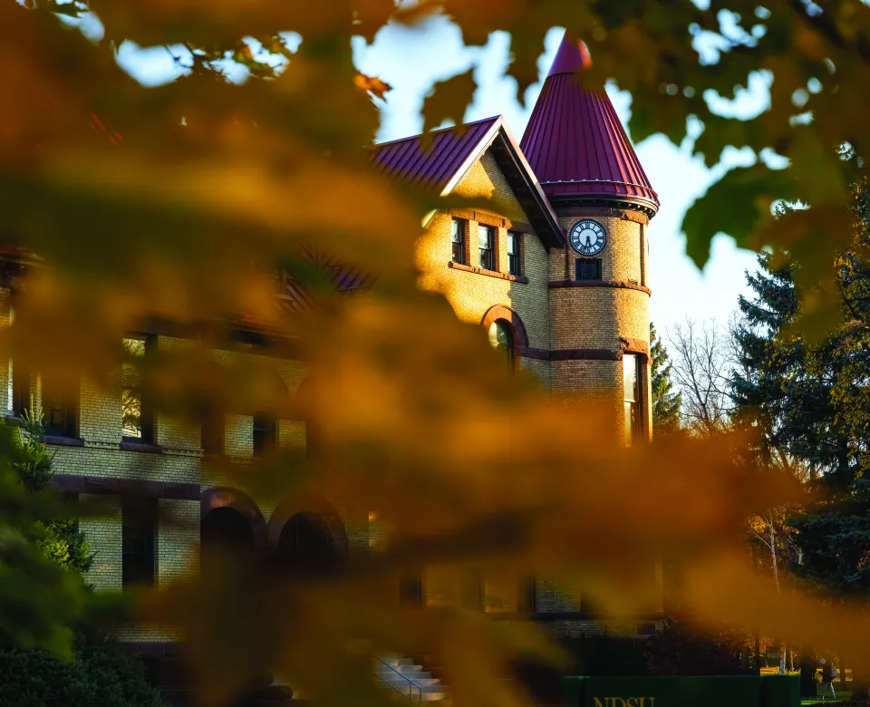 Old Main behind fall trees