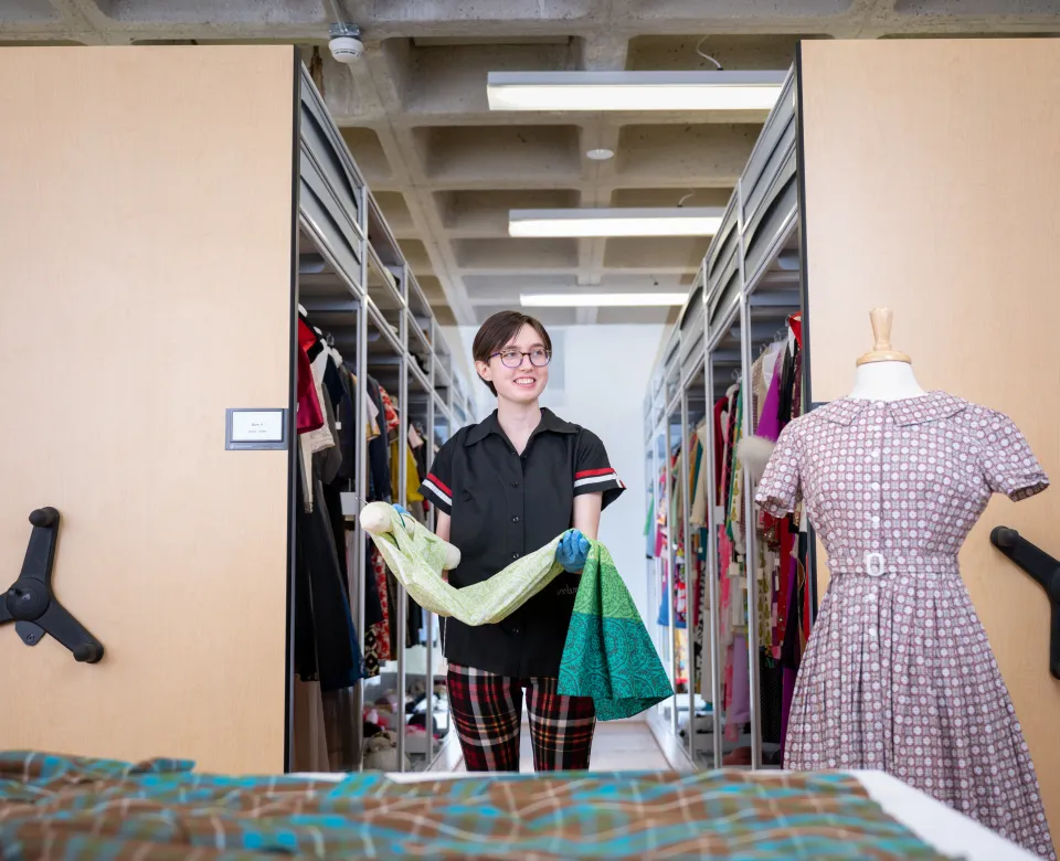 Student holding a dress
