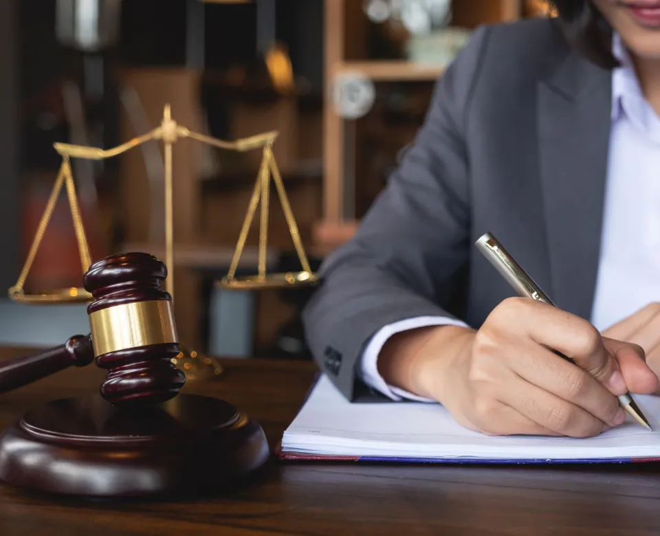 Criminal Justice Career professional sitting at a desk writing in a notebook.