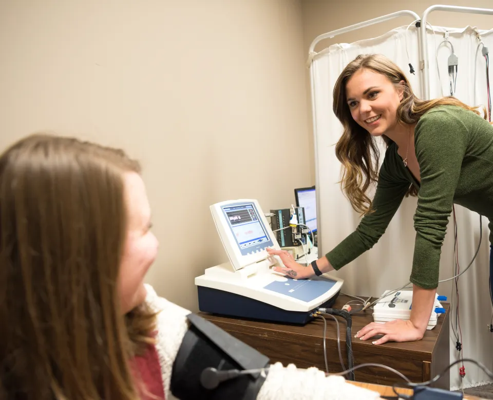 Student working at a computer in a clinical setting.