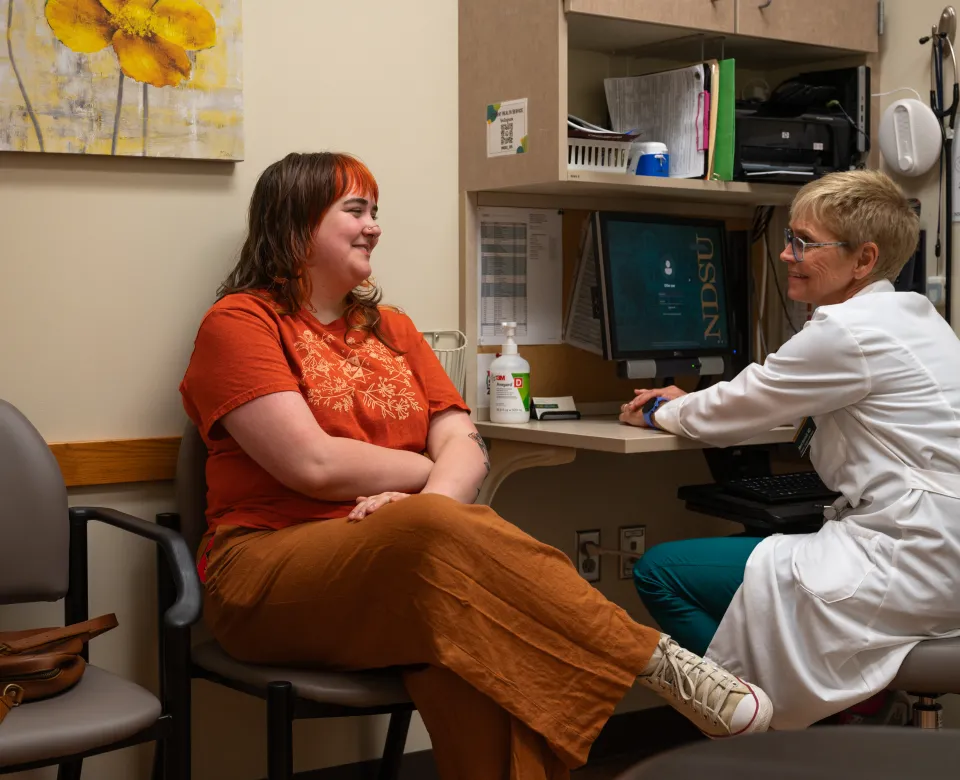 Student meeting with a provider in a Student Health exam room