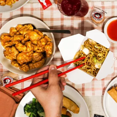 person Eating panda express with chopsticks