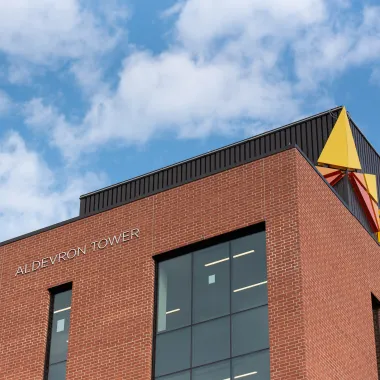 upwards shot of Aldevron Tower displaying name and logo on building 