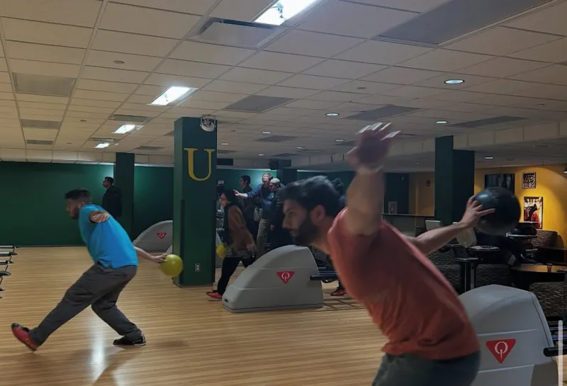 Action shot of students bowling