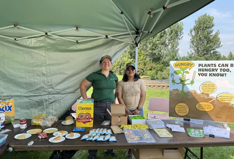 two people smile under tent