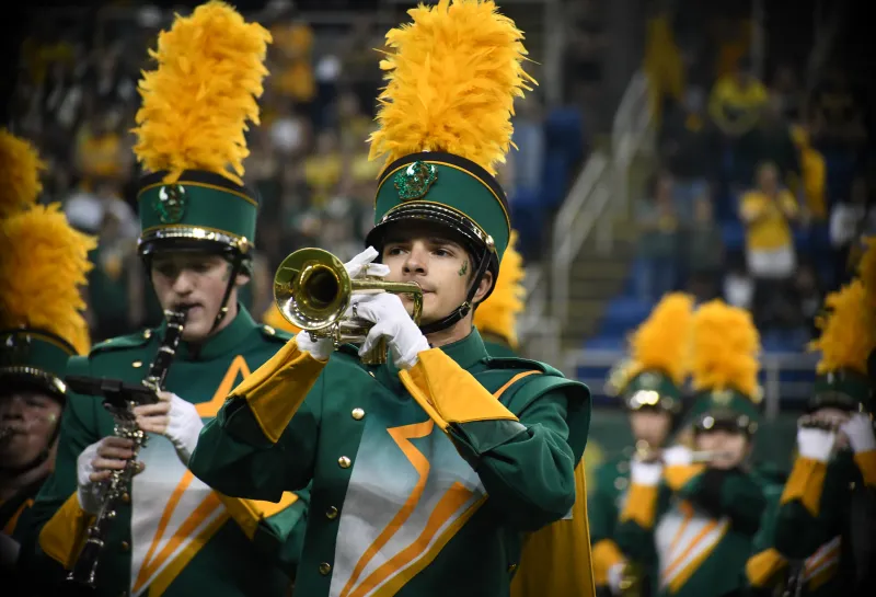 A young man playing trumpet in 线上赌博app's Gold Star Marching Band.