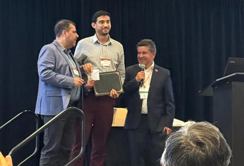 Jose accepting award at Bean Improvement Cooperative meeting