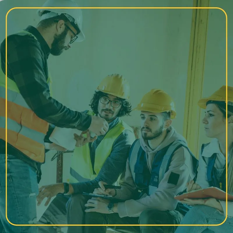 Construction workers with hard hats receiving instructions from supervisor