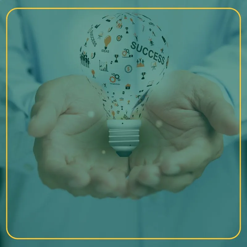 Person holding light bulb with multiple 8dea images including the word Success