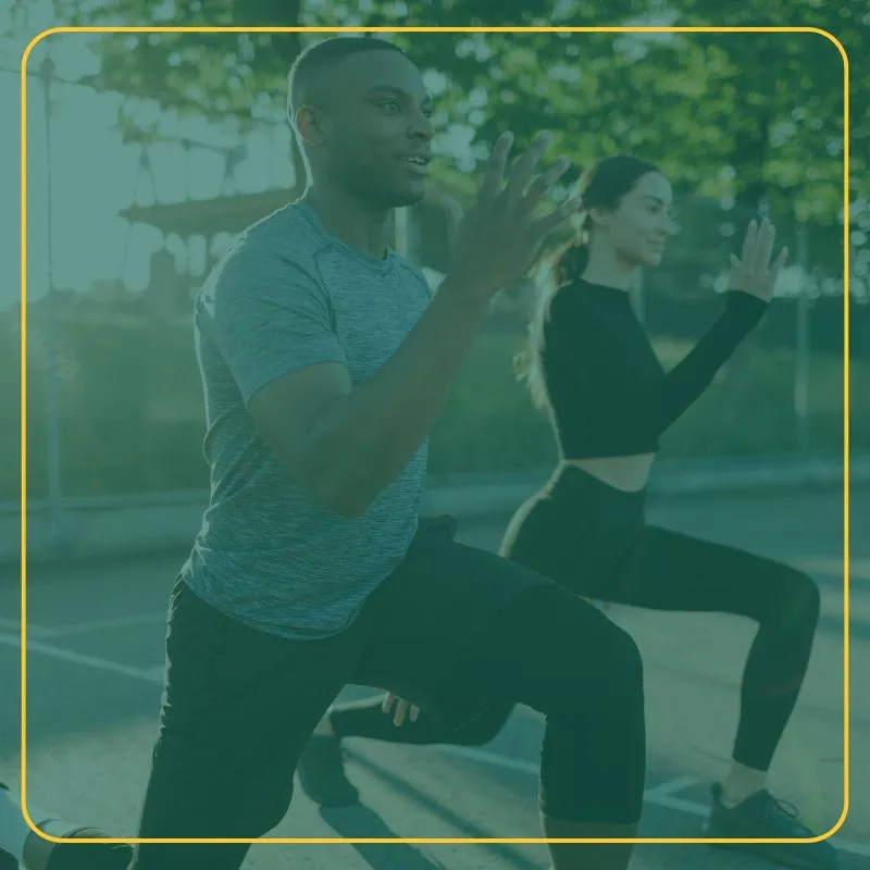 Man and woman outdoors doing the same quad stretch